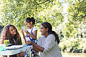 Mother and daughters playing card game