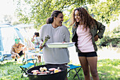 Mother and daughter barbecuing