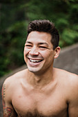 Portrait happy, handsome bare chested man laughing