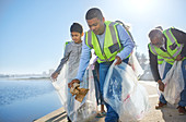 Multi-generation family men volunteering, picking up litter