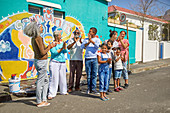 Happy community volunteers celebrating painted mural