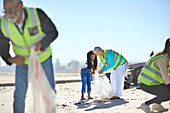 Senior woman and girl volunteer cleaning up litter