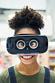 Portrait silly, cross-eyed student wearing VR simulator