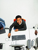 Portrait from above junior high boy student using computer