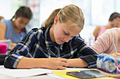 Focused school student doing homework