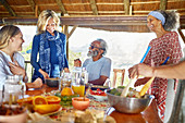 Friends enjoying healthy meal in hut