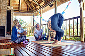 Female yoga instructor demonstrating forward fold in hut