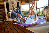 Yoga class stretching in hut