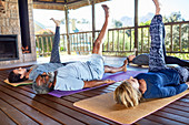 Yoga class stretching legs in hut