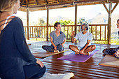 Man and woman talking during yoga class in hut