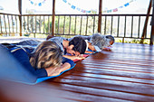 Serene people meditating in hut