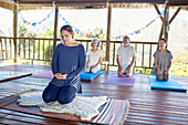 People meditating in hut