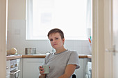 Portrait woman in wheelchair drinking coffee