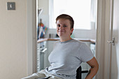 Portrait woman in wheelchair at home