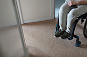 Young woman in wheelchair at home