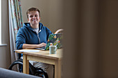 Portrait woman in wheelchair at laptop