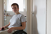 Portrait woman in wheelchair at home