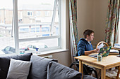 Young women in wheelchair using laptop