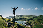 Carefree man standing on rock, Northern Ireland