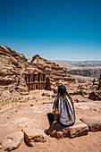 Male traveller with dreadlocks visiting ruins, Petra, Jordan