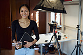 Portrait confident female photographer working in studio