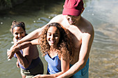 Happy family playing in river