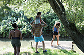 Family on dock at remote stream