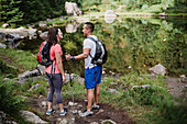 Couple hiking at lake in woods