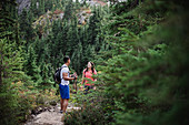 Couple hiking on remote trail in woods