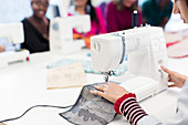 Female fashion designer working at sewing machine