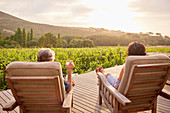 Couple relaxing, drinking wine on resort patio