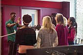 Male conductor leading women singing