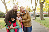 Portrait happy Muslim family in autumn park