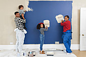 Portrait happy family painting wall