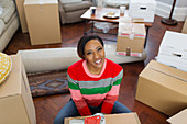 Portrait smiling, confident woman packing moving boxes