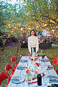 Portrait confident woman hosting dinner garden party