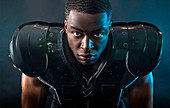 Portrait confident, tough football player wearing pads