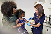 Female pediatrician examining girl