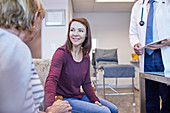 Doctor talking with patients in doctors office