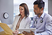 Doctors discussing medical record in clinic