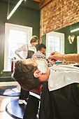 Man receiving a shave in barbershop