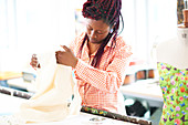 Female fashion designer with fabric in studio