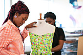 Female fashion designers using dressmakers model