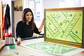 Smiling female art student screen printing
