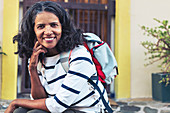 Portrait confident, smiling woman backpacking