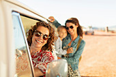 Multi-generation women at van on beach