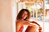 Young woman relaxing on beach hut patio