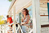 Happy woman relaxing on beach hut patio