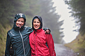 Mother and daughter hiking in rain