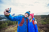Couple taking selfie on mountaintop